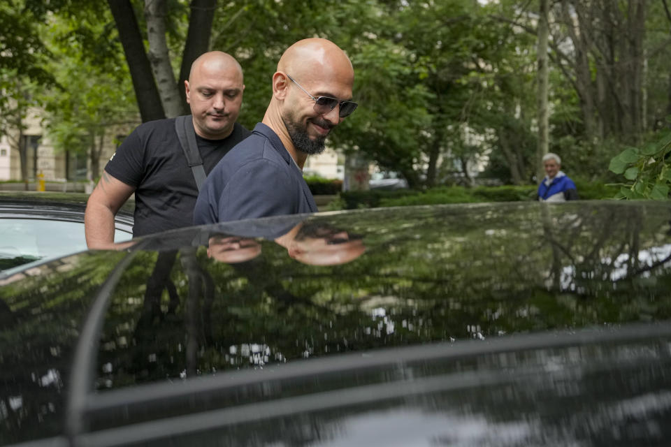 Andrew Tate smiles as he leaves the Bucharest Tribunal in Bucharest, Romania, Wednesday, May 8, 2024. A court in Romania's capital ruled on April 26, that a trial could start but did not set a date for the trial to begin in the case of influencer Andrew Tate, who is charged with human trafficking, rape and forming a criminal gang to sexually exploit women. (AP Photo/Vadim Ghirda)