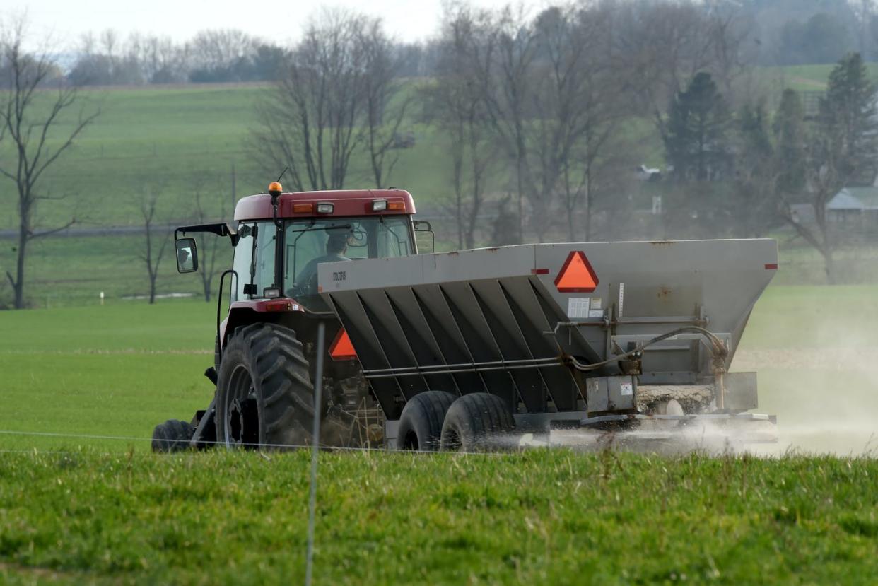 <span class="caption">A farmer spreads fertilizer on a field in Berks County, Pa.</span> <span class="attribution"><a class="link " href="https://www.gettyimages.com/detail/news-photo/farmer-spreads-fertilizer-on-his-field-on-a-saturday-night-news-photo/1315197588" rel="nofollow noopener" target="_blank" data-ylk="slk:Harold Hoch/MediaNews Group/Reading Eagle via Getty Images;elm:context_link;itc:0;sec:content-canvas">Harold Hoch/MediaNews Group/Reading Eagle via Getty Images</a></span>