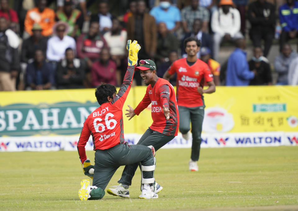 Bangladesh players celebrate a wicket on the final day of the T20 match between Zimbabwe and Bangladesh at Harare Sports Club in Harare, Zimbabwe, Tuesday,August,2, 2022. (AP Photo/Tsvangirayi Mukwazhi)