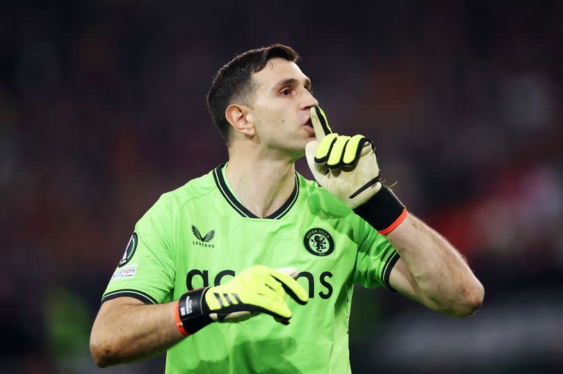 Emiliano Martinez of Aston Villa reacts after saving the first penalty by Nabil Bentaleb of Lille