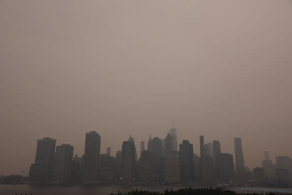 NEW YORK, NEW YORK - JUNE 06: The Manhattan skyline stands shrouded in a reddish haze as a result of Canadian wildfires on June 06, 2023 in New York City. Over 100 wildfires are burning in the Canadian province of Nova Scotia and Quebec resulting in air quality health alerts for the Adirondacks, Eastern Lake Ontario, Central New York and Western New York.  (Photo by Spencer Platt/Getty Images)