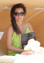 Celebrities in neon fashion: Caroline Flack wore this lime green top on holiday.<br><br>[Splash]