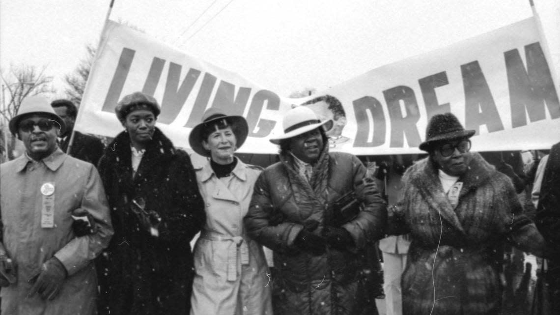 About 1,200 people, including from left, S.T. Roach, Merrylyn Moran-Smith and Lauren Weinberg, braved snow showers and freezing temperatures to march Jan. 19, 1986 in Lexington, KY on the eve the first national observance of Martin Luther King Jr. The 1 1/2-mile march went around the University of Kentucky campus, starting and ending at Memorial Coliseum.