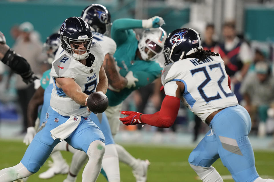 Tennessee Titans quarterback Will Levis (8) hands the ball to running back Derrick Henry (22) during the first half of an NFL football game against the Miami Dolphins, Monday, Dec. 11, 2023, in Miami, Fla. (AP Photo/Lynne Sladky)