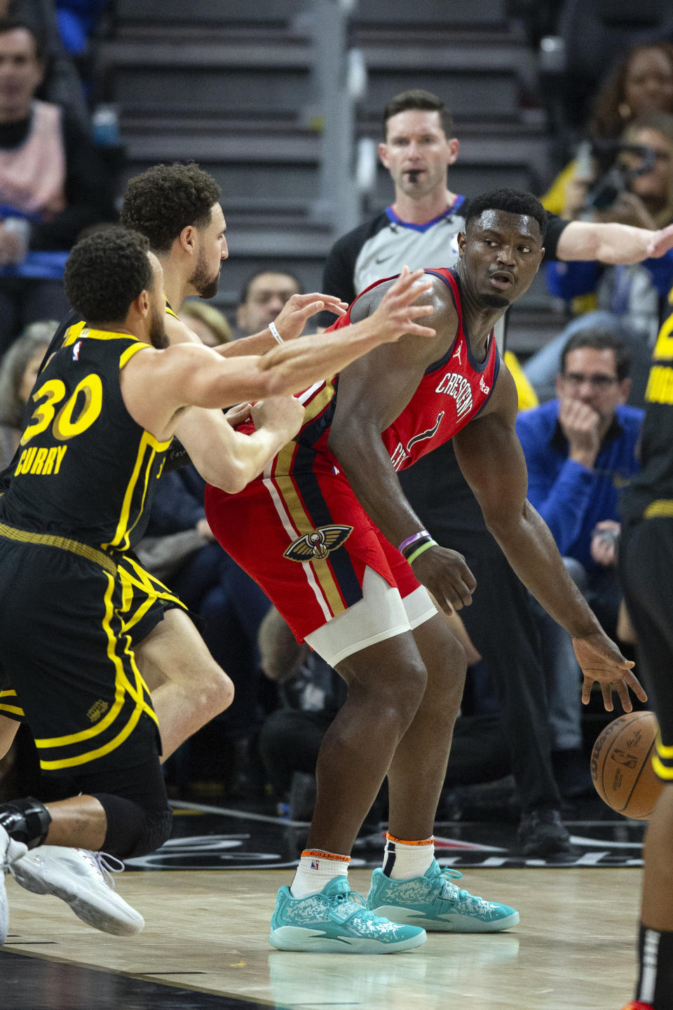 New Orleans Pelicans forward Zion Williamson, right, is double-teamed by Golden State Warriors defenders Stephen Curry (30) and Klay Thompson during the second quarter of an NBA basketball game, Wednesday, Jan. 10, 2024, in San Francisco. (AP Photo/D. Ross Cameron)