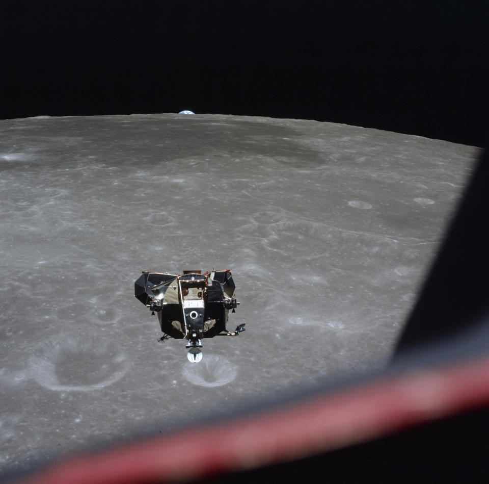This July 21, 1969 photo made available by NASA shows the Lunar Module approaching the Command Module with the Earth visible behind the moon. The shutter speeds on the astronauts’ cameras were too fast to capture the faint light of the stars, astronomer Emily Drabek-Maunder at the Royal Observatory Greenwich in London said. NASA used high shutter speeds to make sure the pictures weren’t overexposed from the bright light on the moon. (Michael Collins/NASA via AP)