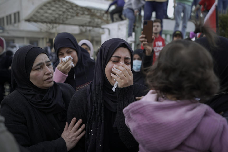 Mourners react during the funeral of three Palestinian militants who were killed by Israeli forces, in the occupied West Bank city of Nablus, Tuesday, Feb. 8, 2022. Israel said it killed three Palestinian militants in Nablus who had been responsible for recent shooting attacks. (AP Photo/Majdi Mohammed)