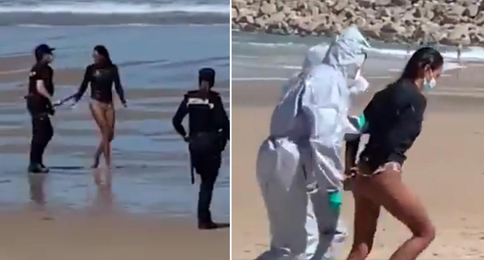 A woman is arrested on a beach in Spain by officers wearing white hazmat suits.