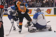 Germany's Maximilian Kastner, center, scores his side's eighth goal past Kazakhstan's goalkeeper Nikita Boyarkin during the preliminary round match between Germany and Kazakhstan at the Ice Hockey World Championships in Ostrava, Czech Republic, Friday, May 17, 2024. (AP Photo/Darko Vojinovic)