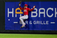 Cincinnati Reds right fielder Jake Fraley collides with the wall after being unable to catch the double by Seattle Mariners' Josh Rojas during the eighth inning of a baseball game Monday, April 15, 2024, in Seattle. (AP Photo/Lindsey Wasson)
