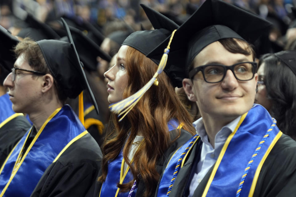 UCLA graduates sit in attendance at their commencement ceremony at Pauley Pavilion, Friday, June 14, 2024 in Los Angeles. (AP Photo/Damian Dovarganes)