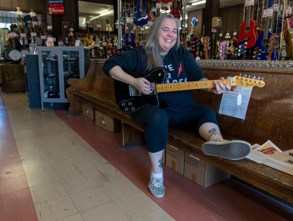 Amy English, granddaughter of store founder Amos Arthur, poses for a photo on Thursday, Nov. 10, 2022, at Arthur’s Music Store in the Fountain Square Neighborhood of Indianapolis. 