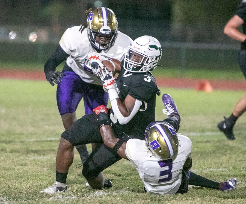 Lakewood Ranch running back Kevin Everhart (3) is brought down by Booker cornerback Dior Keys (3) during their teams matchup in Lakewood Ranch.  MATT HOUSTON/HERALD-TRIBUNE