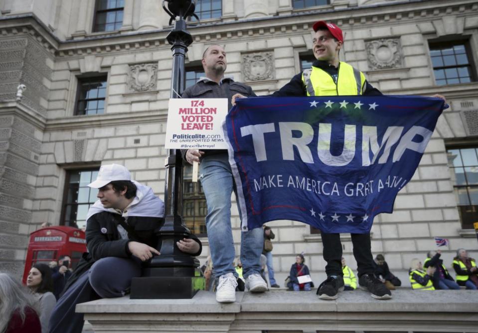 Protesters carring Trump banners at the pro-Brexit rally(AP)