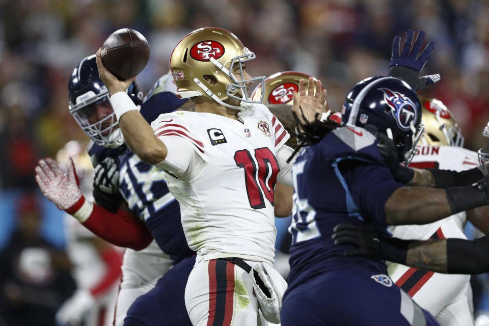 San Francisco 49ers quarterback Jimmy Garoppolo (10) throws as he is pressured by Tennessee Titans defenders in the second half of an NFL football game Thursday, Dec. 23, 2021, in Nashville, Tenn. (AP Photo/Wade Payne)
