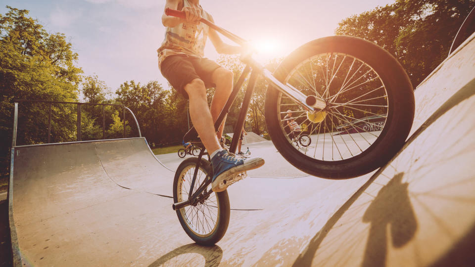 Boy riding a bmx in a park.