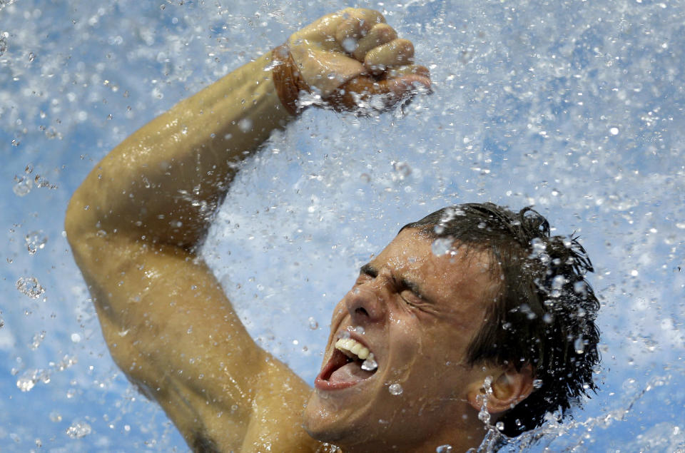 Bronze medalist Thomas Daley from Britain celebrates after the men's 10-meter platform diving final at the Aquatics Centre in the Olympic Park during the 2012 Summer Olympics in London, Saturday, Aug. 11, 2012. (AP Photo/Michael Sohn)<br><br> <b>Related photos:</b> <a href="http://yhoo.it/Q5LouB" rel="nofollow noopener" target="_blank" data-ylk="slk:Olympic diving action;elm:context_link;itc:0;sec:content-canvas" class="link ">Olympic diving action</a>