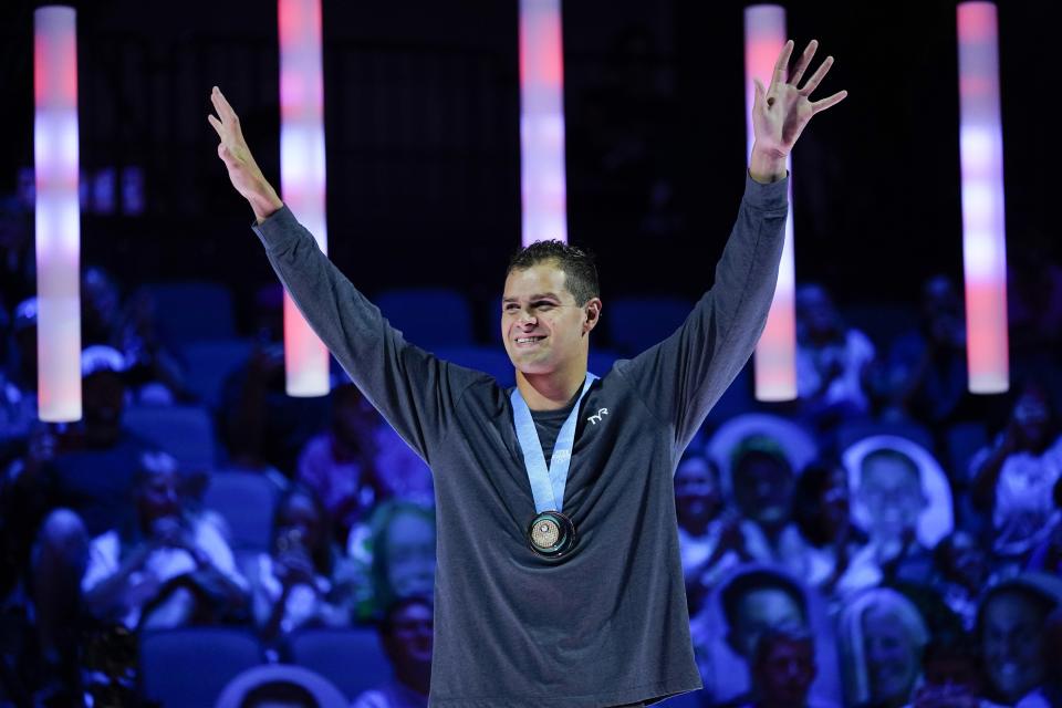 Michael Andrew reacts at the medal ceremony after winning the Men's 100 Breaststroke during wave 2 of the U.S. Olympic Swim Trials on Monday, June 14, 2021, in Omaha, Neb. (AP Photo/Charlie Neibergall)