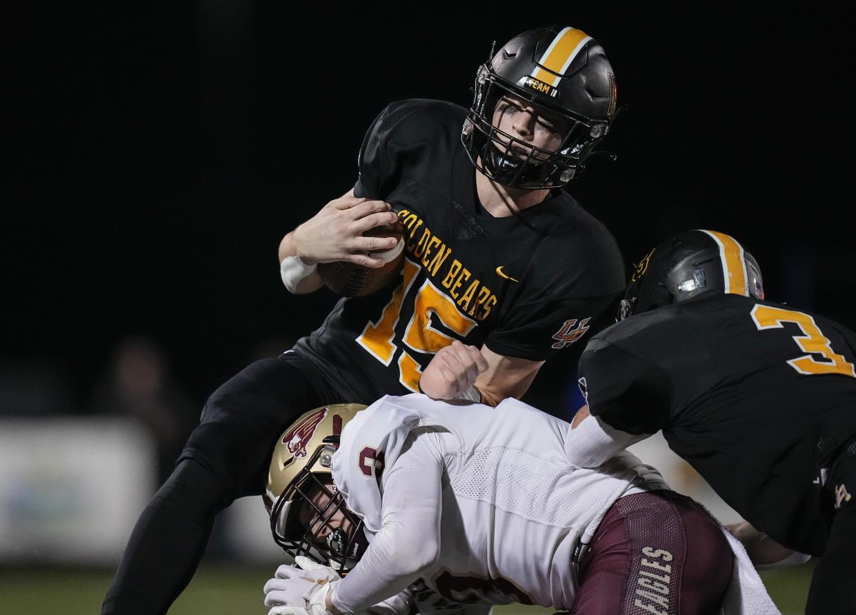 Playing quarterback during a Division I, Region 3 semifinal in 2022, Upper Arlington's Tommy Janowicz takes a hit from New Albany's Dillon Schaub. Janowicz also starred on defense the past three seasons at linebacker and safety.