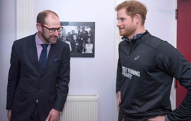 Harry pauses to look at pictures Princess Diana