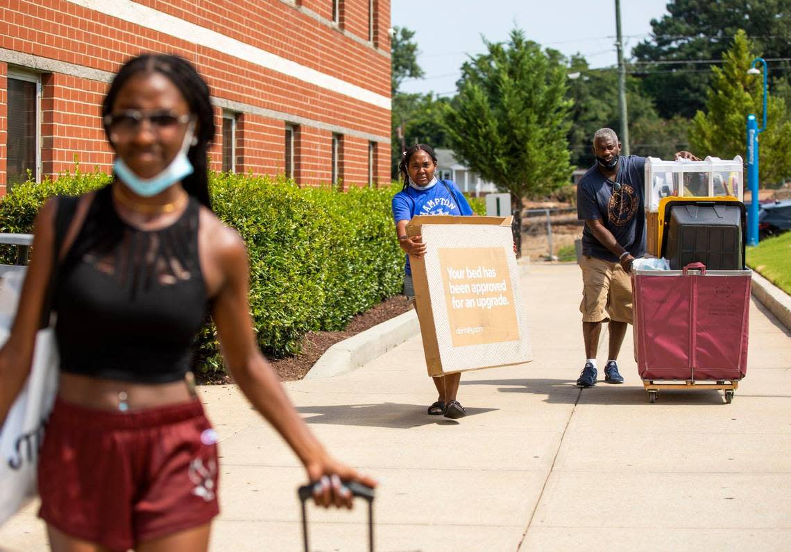 Kelley Robinson, center, and Norbert Robinson, right, help their daughter Niya Robinson, left, move into her dorm for her freshman year at N.C. Central University, on Wednesday, Aug. 11, 2021, in Durham, N.C.