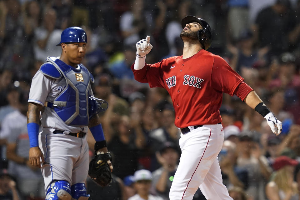 Boston Red Sox's J.D. Martinez celebrates his three-run home run, next to Kansas City Royals catcher Salvador Perez during the third inning of a baseball game at Fenway Park, Wednesday, June 30, 2021, in Boston. (AP Photo/Elise Amendola)