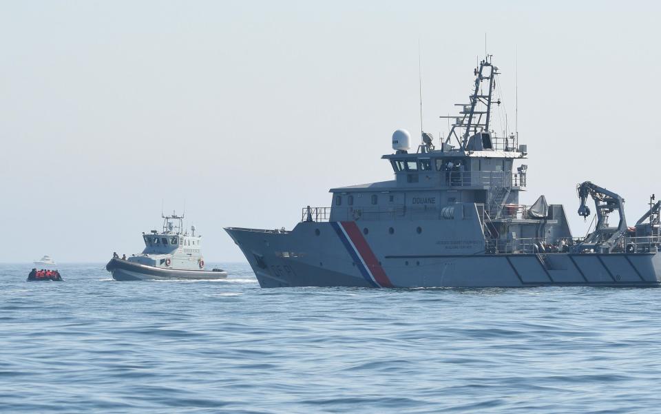 A migrant boat, with a Border Force vessel, and a French navy ship - Steve Finn