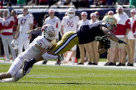 Notre Dame tight end Michael Mayer stretches out after making a catch from quarterback Jack Coan as Wisconsin safety Scott Nelson makes the tackle during the first half of an NCAA college football game Saturday, Sept. 25, 2021, in Chicago. (AP Photo/Charles Rex Arbogast)