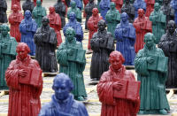 Plastic statuettes of 16th-century Protestant reformer Martin Luther, which are part of the art installation 'Martin Luther - I'm standing here' by German artist Ottmar Hoerl, are pictured in the main square in Wittenberg, eastern Germany August 11, 2010. The installation of 800 one-metre high figurines, based on a statue of Martin Luther on the town square and intended to replace it while it is being renovated, will be open to the public on August 14 and runs till September 12, 2010. Hoerl's creation has created some controversy, with some Protestant theologians saying the statuettes, make a mockery of Luther's achievements. REUTERS/Fabrizio Bensch