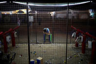 A man takes a rest while waiting for customers at luna park at recently opened international fair in Damascus, Syria, September 12, 2018. REUTERS/Marko Djurica/Files