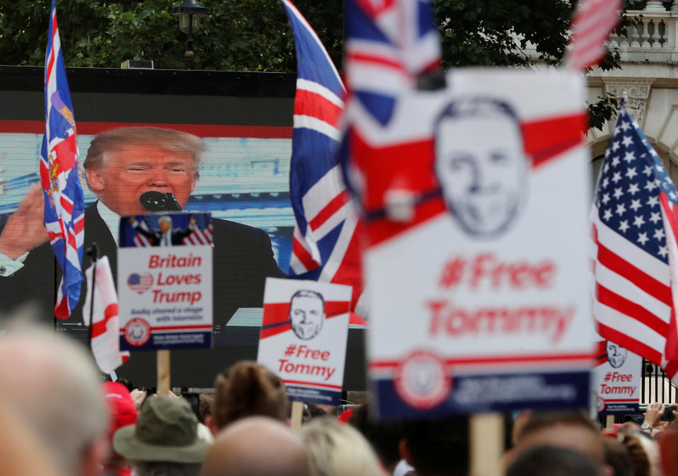 <p>Demonstrators hold placards supporting English Defense League founder Tommy Robinson and President Trump in London, Britain July 14, 2018. (Photo: Yves Herman/Reuters) </p>