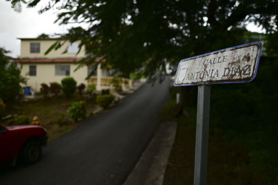 A small, rusty sign identifies Antonia Diaz street in the Cañabón neighborhood of Caguas, Puerto Rico, Wednesday, Sept. 30, 2020. More than half of all homes in Puerto Rico lack a physical address, so the absence of street names and numbers also have created multiple problems ranging from ambulances unable to reach a home in time to a delay in the distribution of aid after Hurricane Maria and a string of recent earthquakes. (AP Photo/Carlos Giusti)