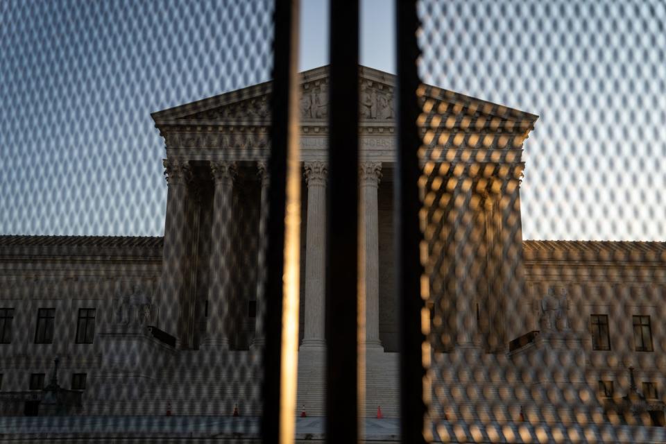 The Supreme Court's Neoclassical pediment is seen through security fencing