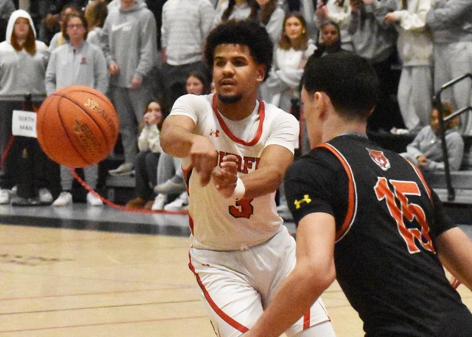 Durfee's Jeyden Espinal passes the ball  the finals of the Skip Karam holiday tournament at B.M.C. Durfee High School December 28, 2023.