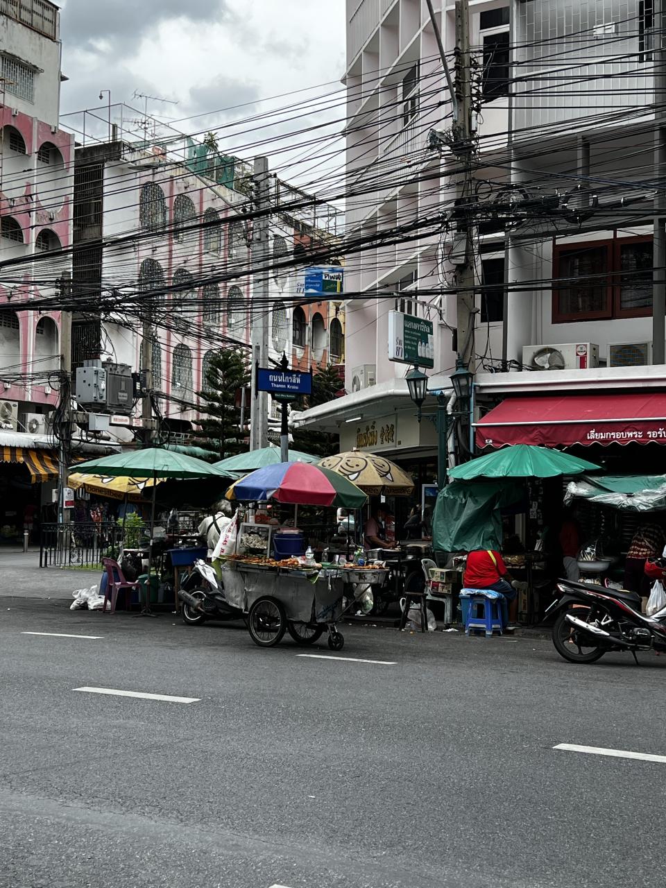 A photo of street food carts along Thanon Kraisi street in Bangkok. 