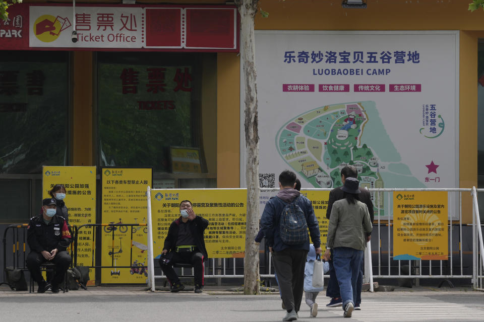Security personnel turn away residents from Chaoyang park which was closed due to pandemic measures on Monday, May 9, 2022, in Beijing. (AP Photo/Ng Han Guan)