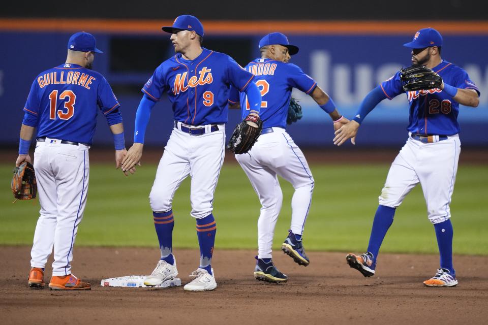 New York Mets' Tommy Pham, right, celebrates with Francisco Lindor (12), Brandon Nimmo (9) and Luis Guillorme (13) after the team's 5-1 win in a baseball game against the Chicago White Sox on Wednesday, July 19, 2023, in New York. (AP Photo/Frank Franklin II)