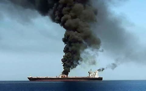 This picture, obtained by AFP from Iranian State TV IRIB, reportedly shows smoke billowing from a tanker  - Credit: IRIB/AFP