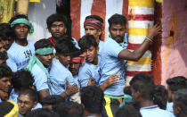 <p>In this Wednesday, Jan. 16, 2019 photo, Indian tamers react as a bull comes charging towards them during a traditional bull-taming festival called Jallikattu, in the village of Palamedu, near Madurai, Tamil Nadu state, India. Jallikattu involves releasing a bull into a crowd of people who are expected to hang on to the animal’s hump for a stipulated distance or hold on to the hump for a minimum of three jumps made by the bull. The sport, performed during the four-day “Pongal” or winter harvest festival, is hugely popular in Tamil Nadu. (AP Photo/Aijaz Rahi) </p>