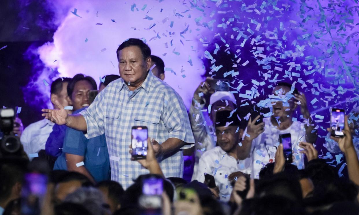 <span>Indonesian presidential candidate Prabowo Subianto (C) dances after polls close in presidential and legislative elections. </span><span>Photograph: Yasuyoshi Chiba/AFP/Getty Images</span>