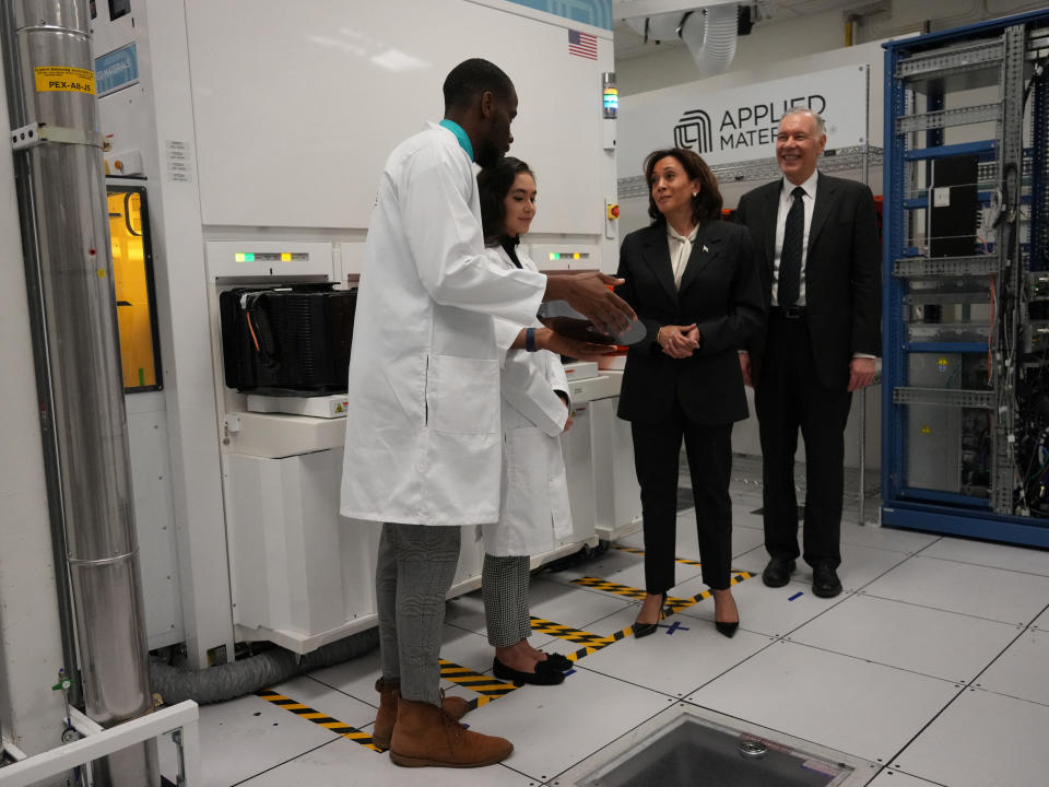 U.S. Vice President Kamala Harris stands next to Applied Materials CEO Gary E. Dickerson and Applied Materials employees Yann Lapnet and Satomi Angelika Murayama as she tours a site where the company plans to build a research facility, in Sunnyvale, California, U.S., May 22, 2023. Jim Wilson/Pool via REUTERS