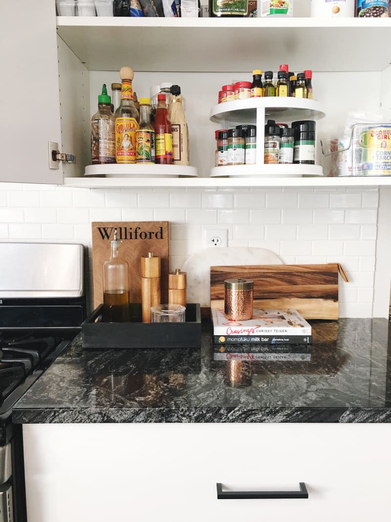 Condiments, spices, sauces, and seasonings are placed on two separate turntables inside a cabinet