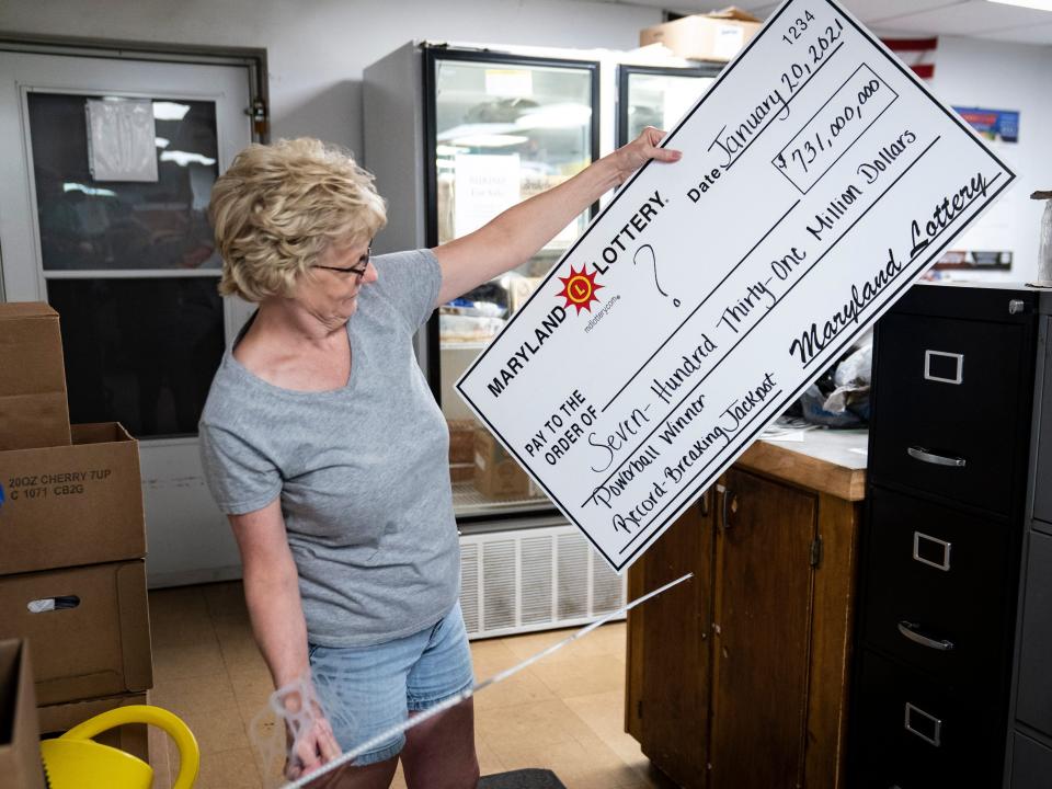 Manager Debbie Bennet shows off the winning check at the Coney Market, which sold the winning ticket, on June 15, 2021, in Lonaconing, Maryland