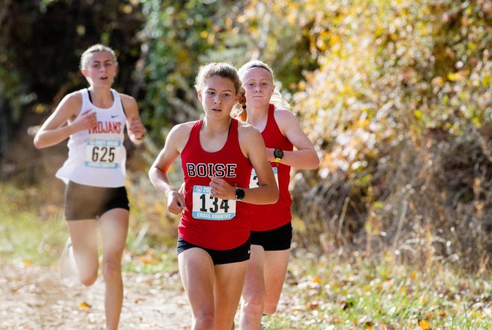 Boise’s Allie Bruce, front, teammate Sammy Smith and Post Falls’ Anastasia Peters compete in the 5A girls state cross country meet Friday at Eagle Island State Park.