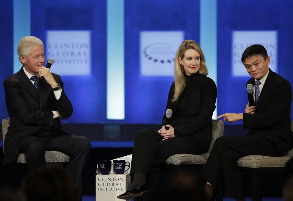 Former US President Bill Clinton (L) and Theranos Founder and CEO Elizabeth Holmes listen as Alibaba Group Executive Chairman Jack Ma (R) speaks during the Clinton Global Initiative annual meeting in New York on September 29, 2015. AFP PHOTO/JOSHUA LOTT (Photo credit should read Joshua LOTT/AFP via Getty Images)