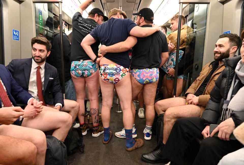 People take part in the annual 'No Trousers On The Tube Day' (No Pants Subway Ride) on the London Underground in central London on January 8, 2023. - 2023 sees the 12th annual No Trousers Tube Ride in London. The day is now marked in over 60 cities around the world. The idea behind 