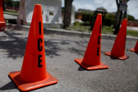 FILE PHOTO: Orange traffic cones with the word "ICE" are seen at ICE facilities as communities brace for a reported wave of ICE deportation raids in Miami