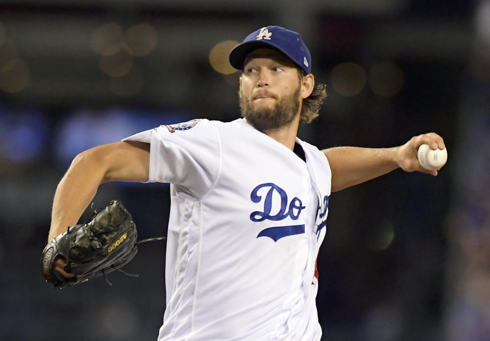 FILE - In this Oct. 5, 2018, file photo, Los Angeles Dodgers starting pitcher Clayton Kershaw throws to an Atlanta Braves batter during the first inning of Game 2 of a National League Division Series baseball game in Los Angeles. The Dodgers and three-time Cy Young Award winner Kershaw reached an agreement on a contract extension Friday, Nov. 2, 2018, that will keep the seven-time All-Star with the club through 2021. (AP Photo/Mark J. Terrill, File)