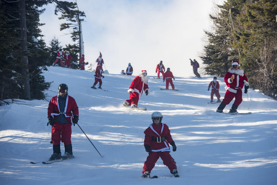 People dressed like Santa Claus are seen enjoying the slopes in western Maine.