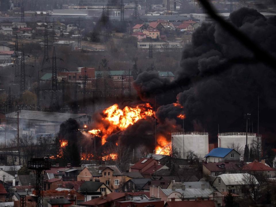 Dark smoke and flames rise from a fire following an air strike in Lviv on Saturday (AFP/Getty)